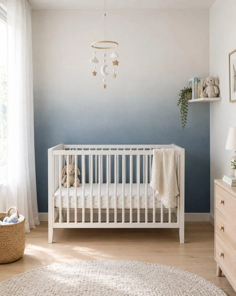 Ombré gradient accent wall in dusty blue — nursery paint idea